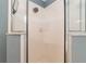 Close up of the white tiled shower with glass door, and shower head at 8053 Sw 62Nd Ave, Ocala, FL 34476