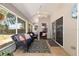 Cozy sunroom featuring comfortable wicker furniture and views of the backyard at 8053 Sw 62Nd Ave, Ocala, FL 34476