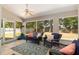 Relaxing sunroom with tile floors, ceiling fan, and views of the backyard at 8053 Sw 62Nd Ave, Ocala, FL 34476