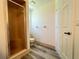 Neutral bathroom with a glass enclosed shower and laminate flooring at 8239 Sw 108Th St, Ocala, FL 34481