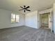 Bedroom with neutral carpet and view into the bathroom at 8239 Sw 108Th St, Ocala, FL 34481