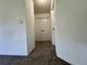Hallway with neutral colored walls, carpet flooring, and access to rooms at 8239 Sw 108Th St, Ocala, FL 34481