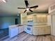 Well-lit kitchen with light-colored cabinets, modern appliances, and wood-look flooring at 8239 Sw 108Th St, Ocala, FL 34481