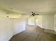 Open living room with neutral carpet, a ceiling fan, and a view through to other rooms at 8239 Sw 108Th St, Ocala, FL 34481
