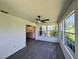 Bright sunroom with carpet, ceiling fan, and multiple windows overlooking the backyard at 8239 Sw 108Th St, Ocala, FL 34481