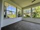 Bright sunroom with large windows offering views of the landscaped yard at 8239 Sw 108Th St, Ocala, FL 34481