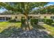 Backyard featuring manicured bushes, mature trees, and partially fenced-in yard at 9661 Sw 95Th Ct # B, Ocala, FL 34481