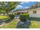 A view of the back of the house, and the fenced-in yard with mature trees at 9661 Sw 95Th Ct # B, Ocala, FL 34481
