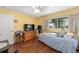 Cozy bedroom with natural light, laminate flooring, and ceiling fan at 9661 Sw 95Th Ct # B, Ocala, FL 34481