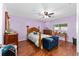 Spacious bedroom featuring wood flooring, a ceiling fan, and bright, natural light at 9661 Sw 95Th Ct # B, Ocala, FL 34481