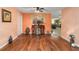Open-concept dining room with hardwood floors leading into the kitchen at 9661 Sw 95Th Ct # B, Ocala, FL 34481
