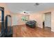 Comfortable living room area with a cozy leather loveseat and hardwood flooring at 9661 Sw 95Th Ct # B, Ocala, FL 34481