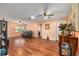 Spacious living room featuring hardwood floors, ceiling fans, and lots of natural light at 9661 Sw 95Th Ct # B, Ocala, FL 34481