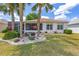 Charming home with a lush lawn, landscaped garden, and a screened-in patio for relaxation and outdoor enjoyment at 9663 Sw 92Nd Place Rd, Ocala, FL 34481