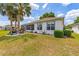 Beautifully landscaped backyard featuring a well-maintained lawn, garden beds, and a screened patio for comfortable outdoor living at 9663 Sw 92Nd Place Rd, Ocala, FL 34481