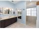 Serene bathroom with double vanity, soft blue walls, and a tiled walk-in shower at 9663 Sw 92Nd Place Rd, Ocala, FL 34481