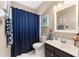 Well lit bathroom with a toilet, single vanity, and shower with curtain at 9663 Sw 92Nd Place Rd, Ocala, FL 34481