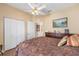 Comfortable bedroom with wood floor, ceiling fan and closet at 9663 Sw 92Nd Place Rd, Ocala, FL 34481