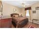Comfortable bedroom with a ceiling fan, tile floors, and natural light at 9663 Sw 92Nd Place Rd, Ocala, FL 34481