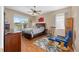 Cozy bedroom featuring tile floors, a ceiling fan, and natural light streaming through the windows at 9663 Sw 92Nd Place Rd, Ocala, FL 34481