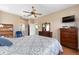 Spacious bedroom with a ceiling fan, tile floors, and ample closet space at 9663 Sw 92Nd Place Rd, Ocala, FL 34481