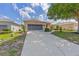 Beautiful home with a long driveway, lush lawn, and attached two-car garage at 9663 Sw 92Nd Place Rd, Ocala, FL 34481