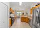 Bright kitchen featuring wood cabinets, stainless steel appliances, and an open layout at 9663 Sw 92Nd Place Rd, Ocala, FL 34481