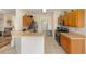 Functional kitchen with wood cabinets, stainless steel appliances, and a breakfast bar for casual dining at 9663 Sw 92Nd Place Rd, Ocala, FL 34481