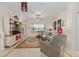 Inviting living room showcasing a TV cabinet, comfortable seating, and natural light from a large window at 9663 Sw 92Nd Place Rd, Ocala, FL 34481