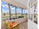 Relaxing screened-in porch with comfortable seating and views of the yard at 9663 Sw 92Nd Place Rd, Ocala, FL 34481