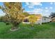 Lush backyard with manicured lawn and shady trees on a sunny day at 9729 Sw 97Th St, Ocala, FL 34481