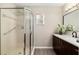 Bathroom features a modern vanity, dark hardware, and a glass shower at 9729 Sw 97Th St, Ocala, FL 34481