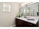 Modern bathroom features dark vanity and glass shower at 9729 Sw 97Th St, Ocala, FL 34481