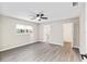 Spacious bedroom with ceiling fan, large window, and neutral walls at 9729 Sw 97Th St, Ocala, FL 34481