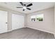 Bright bedroom with wood-look floors, a ceiling fan, and a double door closet at 9729 Sw 97Th St, Ocala, FL 34481