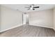 Large bedroom featuring modern ceiling fan and gray plank flooring at 9729 Sw 97Th St, Ocala, FL 34481