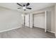Bedroom with wood-look floors, a ceiling fan, a closet, and a connecting bathroom at 9729 Sw 97Th St, Ocala, FL 34481