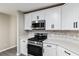 Modern kitchen boasts stainless steel appliances and white countertops at 9729 Sw 97Th St, Ocala, FL 34481