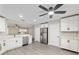 Modern kitchen with stainless appliances, white cabinets, and view to the living area at 9729 Sw 97Th St, Ocala, FL 34481