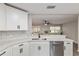Bright kitchen featuring white cabinets, stainless appliances, and quartz countertops at 9729 Sw 97Th St, Ocala, FL 34481