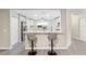 Bright kitchen featuring white cabinets, modern appliances, and breakfast bar at 9729 Sw 97Th St, Ocala, FL 34481