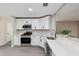 Modern kitchen with stainless appliances, white cabinets, and mosaic tile backsplash at 9729 Sw 97Th St, Ocala, FL 34481