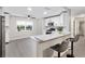 Modern kitchen with stainless steel appliances, white cabinets, and breakfast bar seating at 9729 Sw 97Th St, Ocala, FL 34481