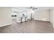 Open floor plan with gray flooring, ceiling fans, and modern kitchen at 9729 Sw 97Th St, Ocala, FL 34481