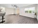 Modern living room with sleek flooring, ceiling fan, and sun-filled windows at 9729 Sw 97Th St, Ocala, FL 34481