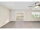 Bright living space featuring new flooring and large sliding doors leading to the sunroom at 9729 Sw 97Th St, Ocala, FL 34481