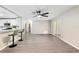 Bright living room with gray flooring, ceiling fan, and sliding glass doors at 9729 Sw 97Th St, Ocala, FL 34481