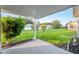 Covered patio overlooking the lush, well-manicured backyard at 9729 Sw 97Th St, Ocala, FL 34481