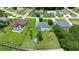 Aerial view of a property with an enclosed pool, green lawns, and mature trees surrounding the home at 11140 Sw 53Rd Cir, Ocala, FL 34476