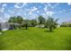 An expansive backyard with lush green grass, trees, and a small building in a residential area at 11140 Sw 53Rd Cir, Ocala, FL 34476